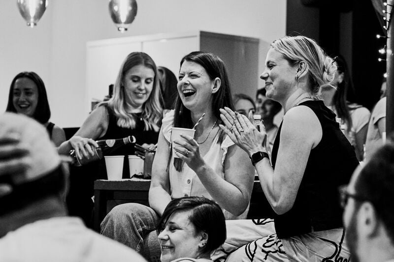 STM AGENCY Summer social Emily and Laurie clapping B&W